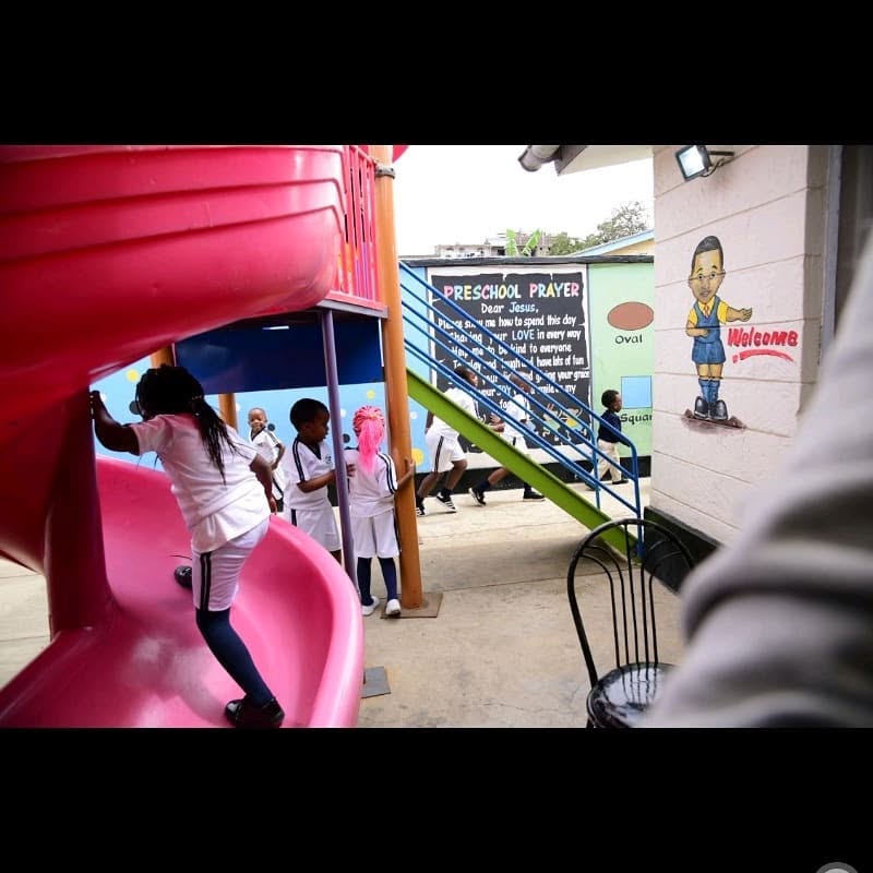 Children playing on the slide in the school playground