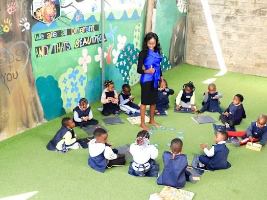 Pre-school children seated together for a guided group lesson