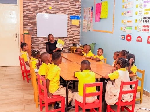 Teacher reading a storybook to a class of young learners